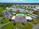 Aerial view of the community clubhouse, pool, tennis courts, parking, and the scenic lake at 1811 Sherwood Hill Dr, Lakeland, FL 33810