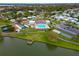 Community clubhouse and pool area with tennis courts, parking, and a dock over the lake at 1811 Sherwood Hill Dr, Lakeland, FL 33810