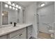 Bright bathroom featuring a vanity, toilet, and glass-door shower with safety bars at 1811 Sherwood Hill Dr, Lakeland, FL 33810