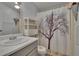 Charming bathroom with decorative shower curtain, marble sink, and overhead lighting at 1811 Sherwood Hill Dr, Lakeland, FL 33810
