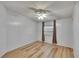 Bright bedroom with wood-look floors, ceiling fan, and a window with blinds at 1811 Sherwood Hill Dr, Lakeland, FL 33810