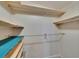 Open closet with wood shelving and silver clothing rod, perfect for organizing clothes at 1811 Sherwood Hill Dr, Lakeland, FL 33810