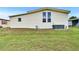 The exterior of the property featuring the siding, windows, and a grassy yard at 1811 Sherwood Hill Dr, Lakeland, FL 33810
