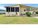 A quaint home featuring a screened porch and a covered carport at 1811 Sherwood Hill Dr, Lakeland, FL 33810