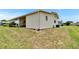 Exterior home view highlighting the yard, siding, and covered patio space at 1811 Sherwood Hill Dr, Lakeland, FL 33810