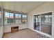 Carpeted Florida room features several windows and a sliding glass door at 1811 Sherwood Hill Dr, Lakeland, FL 33810