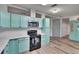 Eat in kitchen featuring blue cabinets and black appliances at 1811 Sherwood Hill Dr, Lakeland, FL 33810