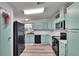 Updated kitchen with modern appliances, light blue cabinets, and wood-look laminate flooring at 1811 Sherwood Hill Dr, Lakeland, FL 33810