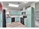 Eat in kitchen featuring blue cabinets and black appliances at 1811 Sherwood Hill Dr, Lakeland, FL 33810