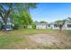 View of backyard with large trees, shed, house, trailer, and lots of space at 1830 Casco, Lakeland, FL 33801