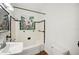 Bright bathroom with a tub, sink, and toilet; featuring classic white tile with a black border at 1830 Casco, Lakeland, FL 33801