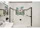 Clean, well-lit bathroom featuring white tile with a black border and colorful shower curtain at 1830 Casco, Lakeland, FL 33801