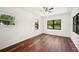 Bright bedroom featuring wood floors, large windows, and neutral tones providing a serene space at 1830 Casco, Lakeland, FL 33801
