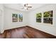 Inviting bedroom featuring wood floors, a ceiling fan, and ample natural light from large windows at 1830 Casco, Lakeland, FL 33801