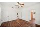 Comfortable bedroom featuring rich wood floors, ceiling fan, closet, and neutral tones at 1830 Casco, Lakeland, FL 33801