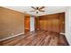 Cozy bedroom features a brick wall, unique built-in wooden cabinets, and modern vinyl floors at 1830 Casco, Lakeland, FL 33801