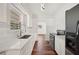 Modern kitchen featuring white cabinets, quartz countertops, a stainless steel sink, and updated appliances at 1830 Casco, Lakeland, FL 33801
