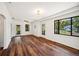 Bright living room with wood floors, ceiling fan, and windows with views of the outdoors at 1830 Casco, Lakeland, FL 33801