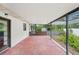 Covered outdoor patio featuring a concrete floor, partial screen enclosure, and a view of the backyard at 1830 Casco, Lakeland, FL 33801