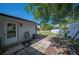 Backyard featuring a brick home, a patio area, and a well-manicured lawn at 1948 Oakland Park Dr, Lake Wales, FL 33898
