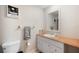 Bright bathroom with a white vanity, a large mirror, and unique fixtures, complemented by a framed wall decoration at 1948 Oakland Park Dr, Lake Wales, FL 33898
