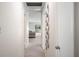 View down a bright hallway leading to a living room with a gray sofa and natural light streaming through the windows at 1948 Oakland Park Dr, Lake Wales, FL 33898