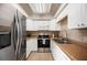 Well-equipped kitchen featuring stainless steel appliances, white cabinetry, and updated countertops at 1948 Oakland Park Dr, Lake Wales, FL 33898