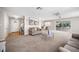 Open-concept living room with carpet, featuring a cozy seating area and access to dining area with a view to lanai at 1948 Oakland Park Dr, Lake Wales, FL 33898