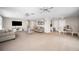 Expansive living room with open layout, carpeting, and a smooth transition to the dining area and kitchen at 1948 Oakland Park Dr, Lake Wales, FL 33898