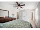 View of main bedroom featuring a ceiling fan, dresser, closet, and ensuite bathroom at 1948 Oakland Park Dr, Lake Wales, FL 33898