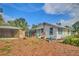 View of the house showing off the full backyard. Landscape includes foliage and fresh wood mulch at 200 Spurlock Rd, Frostproof, FL 33843