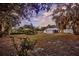 Beautiful backyard with mature trees and landscaping at 200 Spurlock Rd, Frostproof, FL 33843