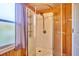 Bathroom shower with adjustable shower head and frosted glass door at 200 Spurlock Rd, Frostproof, FL 33843
