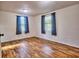 Spacious bedroom with two windows offering lots of light and wood look flooring at 200 Spurlock Rd, Frostproof, FL 33843