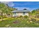 Charming home featuring freshly cut green grass and a well-maintained landscape at 200 Spurlock Rd, Frostproof, FL 33843