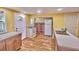 Eat-in kitchen featuring white appliances, laminate floors, and white countertops at 200 Spurlock Rd, Frostproof, FL 33843