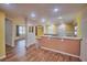 Open-concept living area adjacent to the kitchen featuring laminate floors and neutral paint at 200 Spurlock Rd, Frostproof, FL 33843
