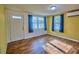 Inviting living room featuring wood-look floors, natural light, and neutral yellow walls at 200 Spurlock Rd, Frostproof, FL 33843