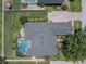 Aerial view of the home showcasing the roof, pool, backyard, and surrounding landscape at 2026 Indian Sky Cir, Lakeland, FL 33813