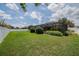 Lush backyard with a screened lanai, mature landscaping, and a serene setting at 2026 Indian Sky Cir, Lakeland, FL 33813