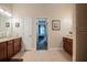 A spacious bathroom leads into a bedroom and features dual sinks and vanities with cherry cabinets at 2026 Indian Sky Cir, Lakeland, FL 33813