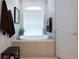Bright bathroom with a soaking tub, large window, neutral tiling, and brown accent towels at 2026 Indian Sky Cir, Lakeland, FL 33813