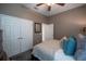 A cozy bedroom with a double door closet, queen bed, and neutral decor at 2026 Indian Sky Cir, Lakeland, FL 33813