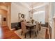 Elegant dining room featuring a chandelier, a large window, and classic wainscoting details at 2026 Indian Sky Cir, Lakeland, FL 33813