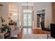 Bright foyer with hardwood floors, decorative glass front doors and chandelier lighting at 2026 Indian Sky Cir, Lakeland, FL 33813