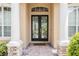 Close-up of the front entrance showcasing leaded glass double doors and decorative pillars at 2026 Indian Sky Cir, Lakeland, FL 33813