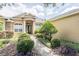 Elegant home exterior showcasing a well-manicured front yard and stone and stucco detailing near the entrance at 2026 Indian Sky Cir, Lakeland, FL 33813