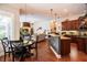 Open-concept kitchen with a central island, pendant lighting, and rich wood cabinetry is perfect for entertaining at 2026 Indian Sky Cir, Lakeland, FL 33813