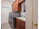 Functional laundry room with a sink, plenty of storage, and modern washer and dryer units at 2026 Indian Sky Cir, Lakeland, FL 33813