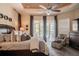 Bright main bedroom with a ceiling fan, sitting area, and sliding glass doors leading to a pool at 2026 Indian Sky Cir, Lakeland, FL 33813